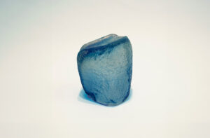 Blue sculpture by Dolores Furtado in front of a plain white backdrop